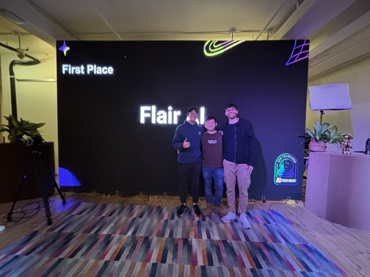 Shan Yuxuan and teammates in front of a screen reading First Place, Flair AI