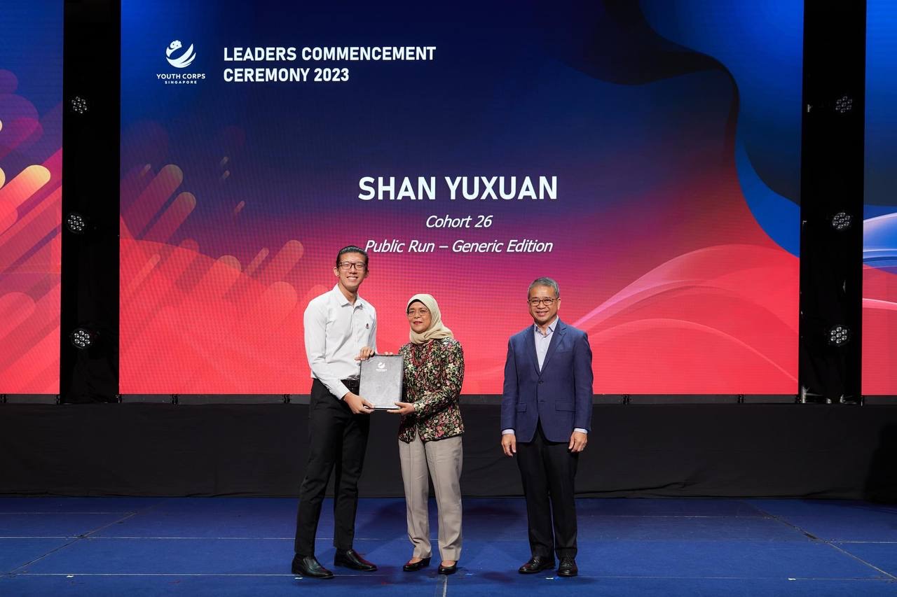 Shan Yuxuan receiving a certificate from President Halimah Yacob at the Youth Corps Leaders Commencement Ceremony 2023